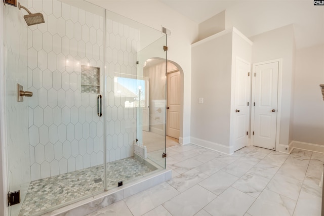 bathroom with a shower with shower door