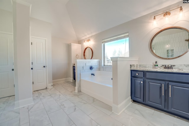 bathroom featuring a bathing tub, vanity, and lofted ceiling