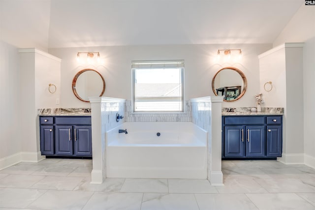 bathroom featuring a bath, vanity, and lofted ceiling