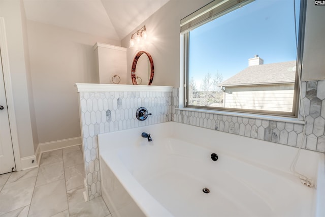 bathroom with a bathtub and lofted ceiling