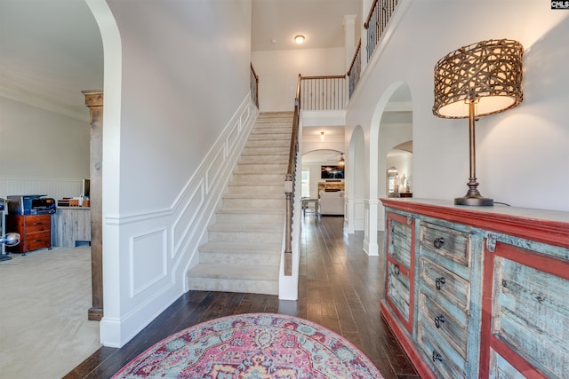 entryway featuring dark hardwood / wood-style flooring and ornamental molding