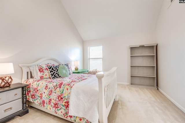 carpeted bedroom with lofted ceiling