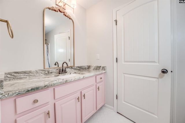 bathroom featuring tile patterned flooring and vanity