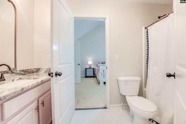 bathroom featuring vanity, a shower with shower curtain, and toilet