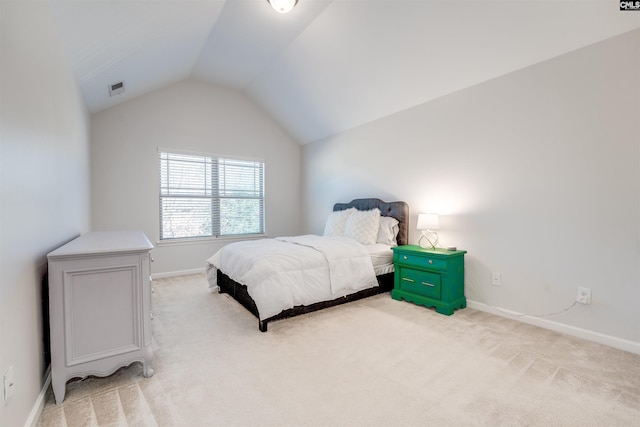 bedroom featuring light carpet and lofted ceiling