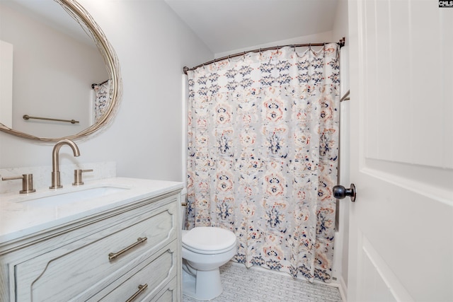 bathroom with tile patterned flooring, vanity, and toilet