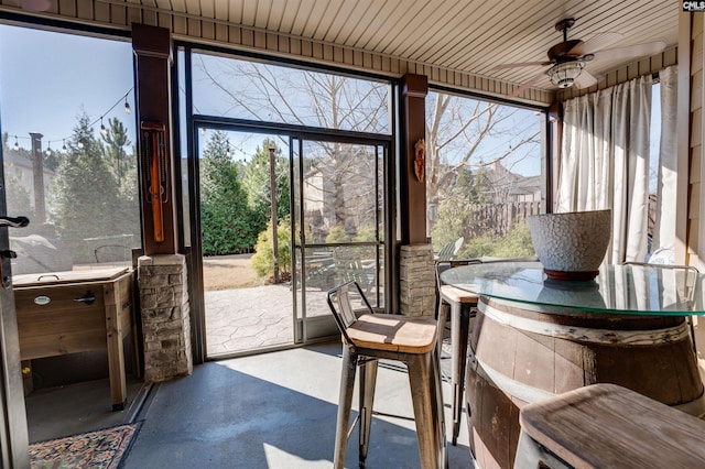 sunroom / solarium with ceiling fan