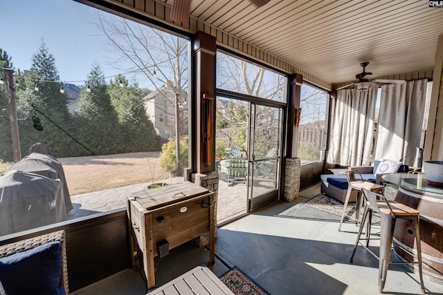 sunroom featuring ceiling fan