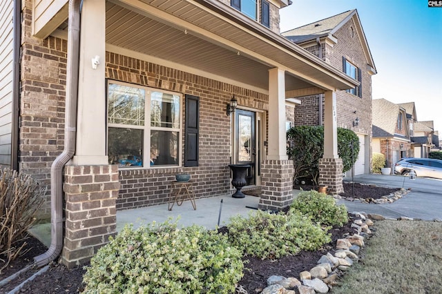 view of exterior entry with a porch