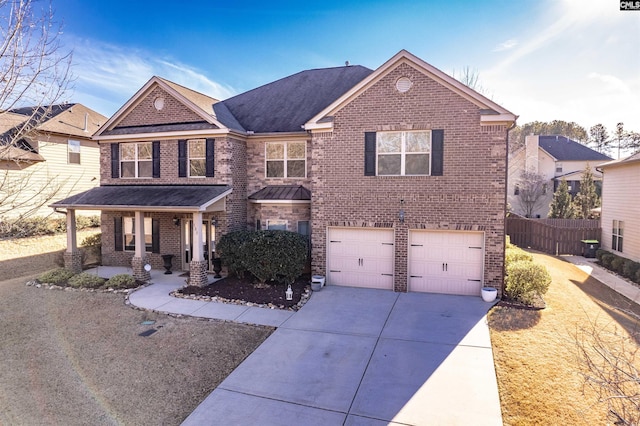 view of front of property featuring covered porch and a garage