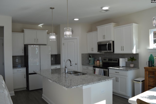 kitchen with white cabinets, sink, stainless steel appliances, and a center island with sink