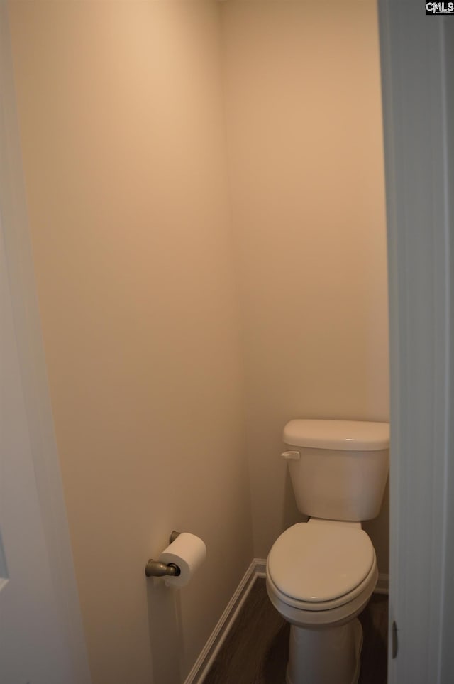 bathroom with wood-type flooring and toilet