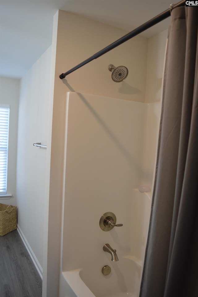 bathroom featuring shower / bath combination with curtain and hardwood / wood-style flooring