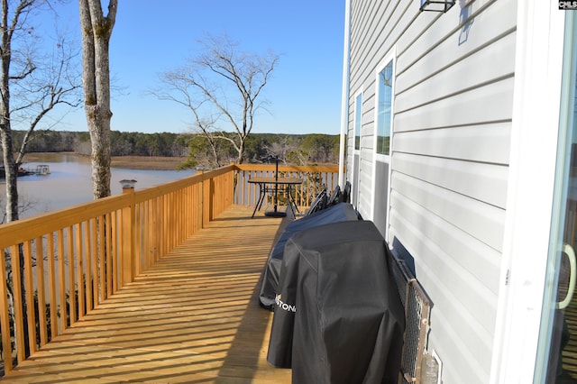 wooden deck featuring a grill and a water view