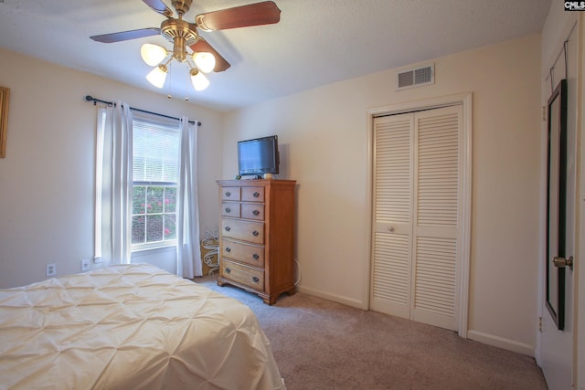 carpeted bedroom with a closet and ceiling fan