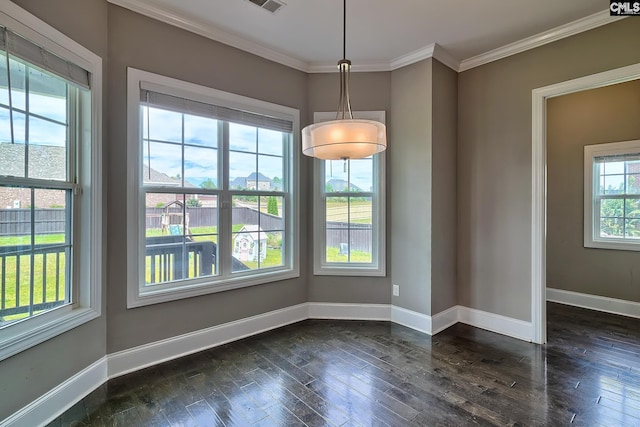 unfurnished dining area featuring dark wood-type flooring, a healthy amount of sunlight, and ornamental molding