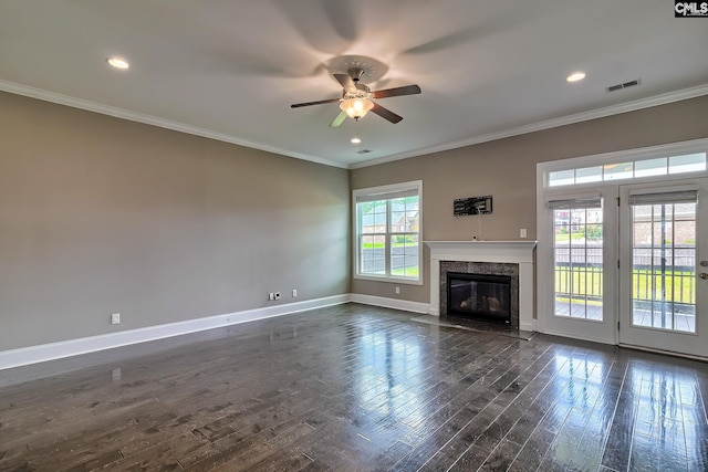 unfurnished living room with a high end fireplace, dark hardwood / wood-style flooring, ceiling fan, and ornamental molding