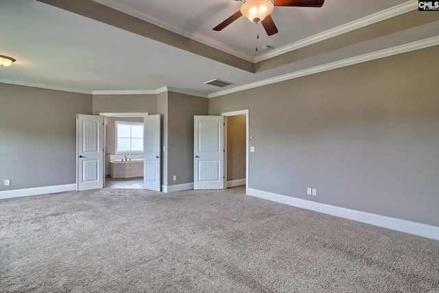 unfurnished bedroom with ceiling fan, light colored carpet, ensuite bathroom, and crown molding