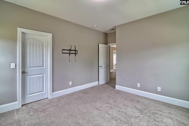 unfurnished bedroom featuring light colored carpet