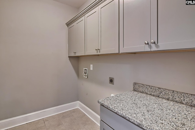 laundry area with cabinets, hookup for a washing machine, and hookup for an electric dryer