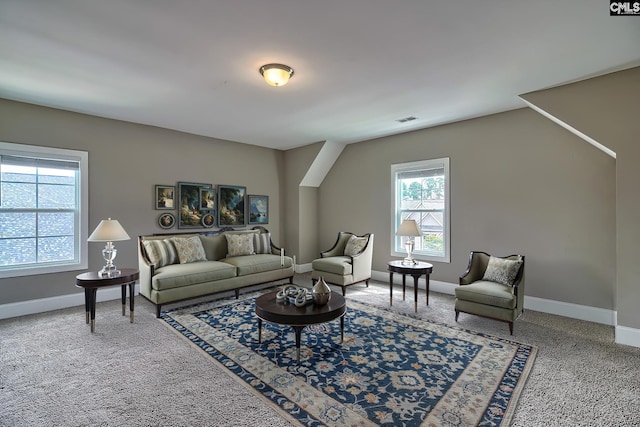 carpeted living room with vaulted ceiling