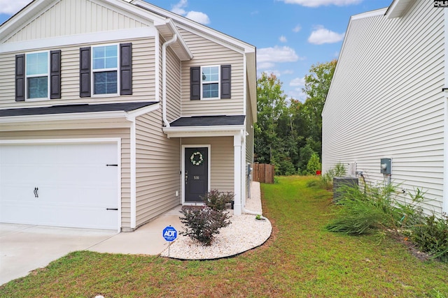 view of front of house featuring a garage and a front yard