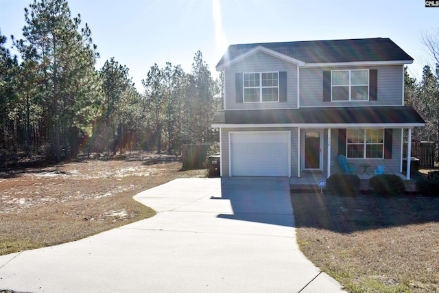 view of front property with covered porch and a garage