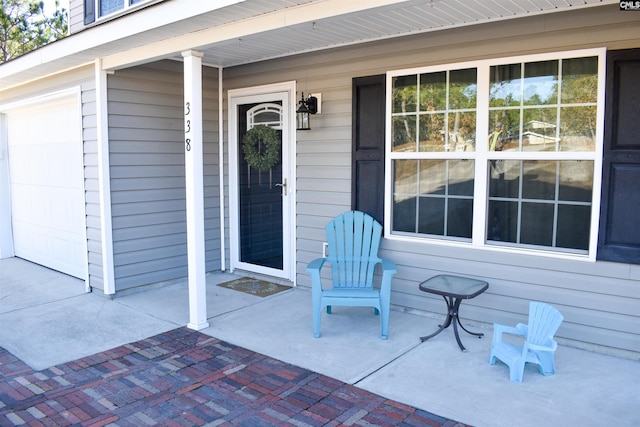 property entrance featuring a porch and a garage