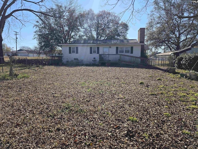 rear view of house with a wooden deck