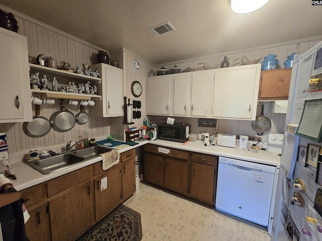 kitchen with sink, white cabinets, white appliances, and ornamental molding