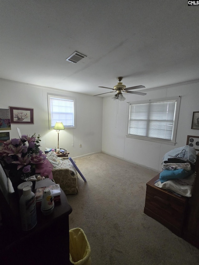 carpeted living room with ceiling fan