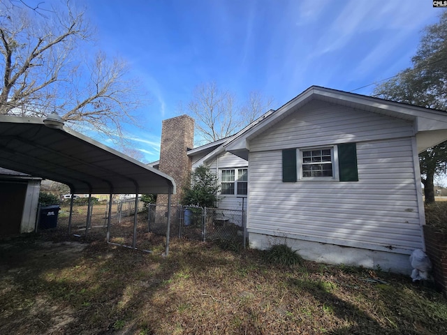 view of side of home with a carport