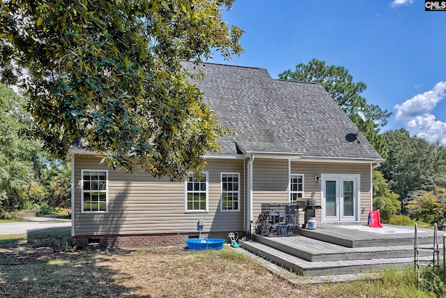 rear view of house featuring french doors and a deck