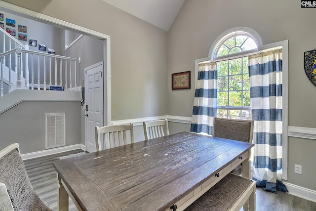 dining area with vaulted ceiling and hardwood / wood-style flooring