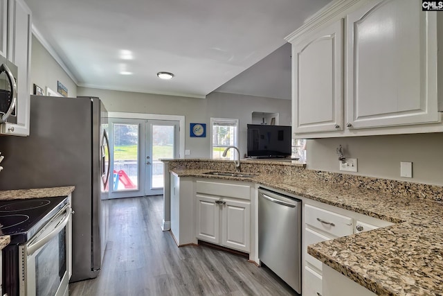 kitchen with white cabinets, french doors, stainless steel appliances, and sink