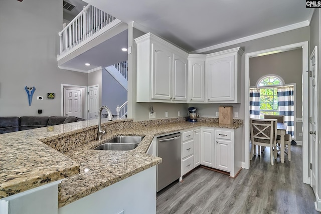 kitchen with white cabinetry, sink, stainless steel dishwasher, and light stone counters