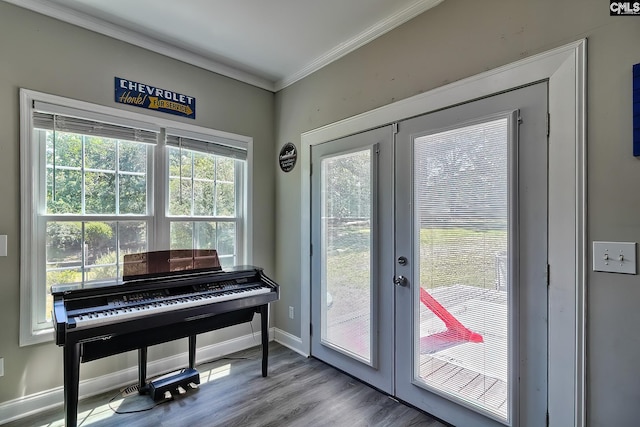 misc room featuring light hardwood / wood-style floors, crown molding, and french doors