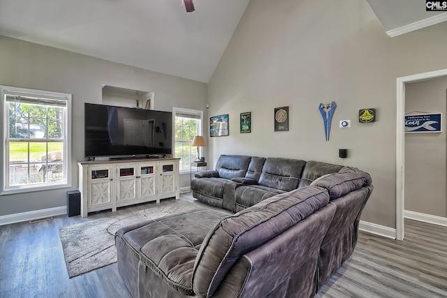 living room featuring hardwood / wood-style flooring, ceiling fan, and high vaulted ceiling