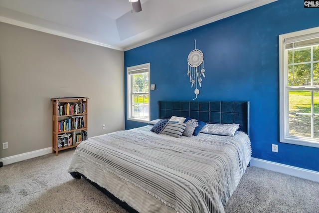 carpeted bedroom with ceiling fan and ornamental molding