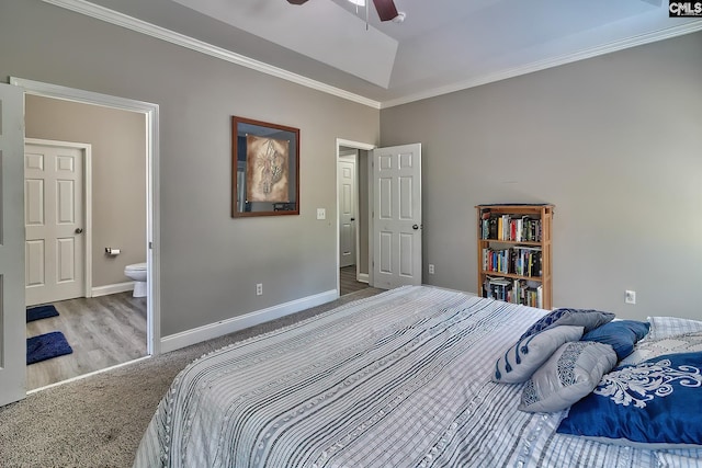 carpeted bedroom with ceiling fan, ensuite bathroom, and ornamental molding