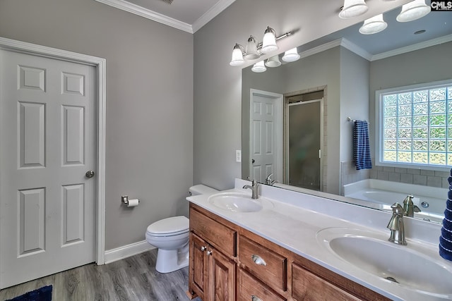 full bathroom with hardwood / wood-style floors, vanity, toilet, ornamental molding, and independent shower and bath