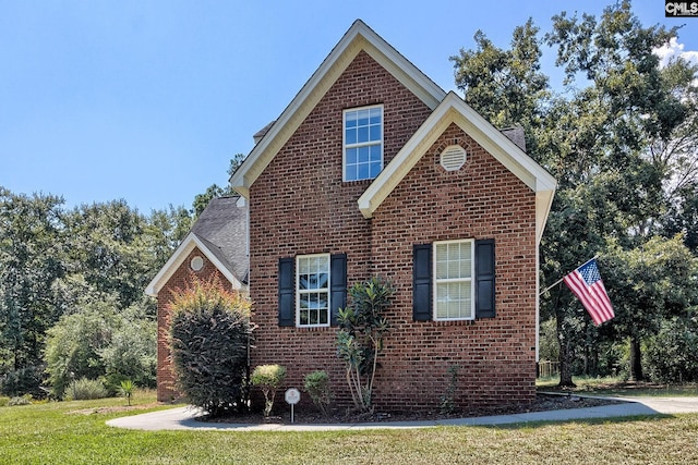 view of side of home featuring a yard