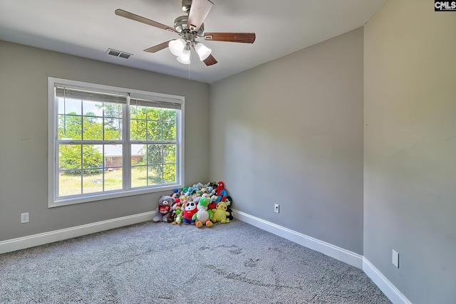 recreation room with ceiling fan and carpet