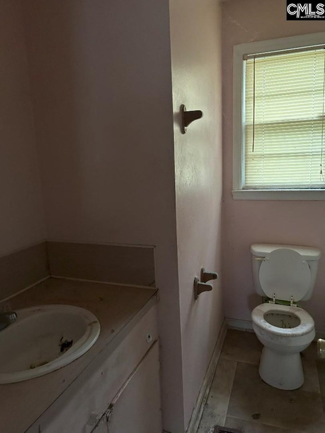 bathroom with tile patterned floors, vanity, and toilet