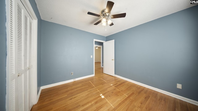 unfurnished bedroom with ceiling fan and light hardwood / wood-style floors