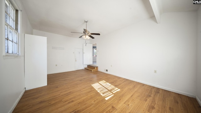 unfurnished room with vaulted ceiling with beams, ceiling fan, and wood-type flooring