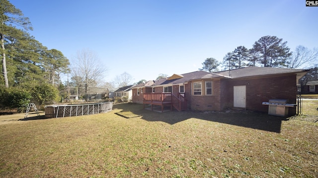 view of yard with a pool side deck