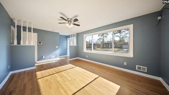 empty room with hardwood / wood-style flooring and ceiling fan