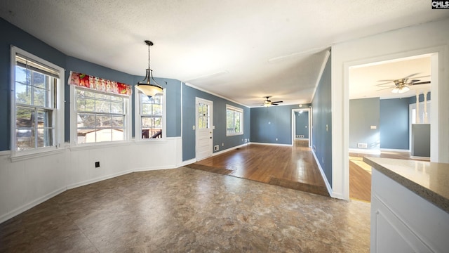 interior space featuring a textured ceiling, plenty of natural light, and ceiling fan