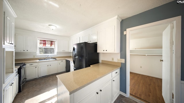 kitchen featuring black appliances, white cabinets, sink, and a textured ceiling